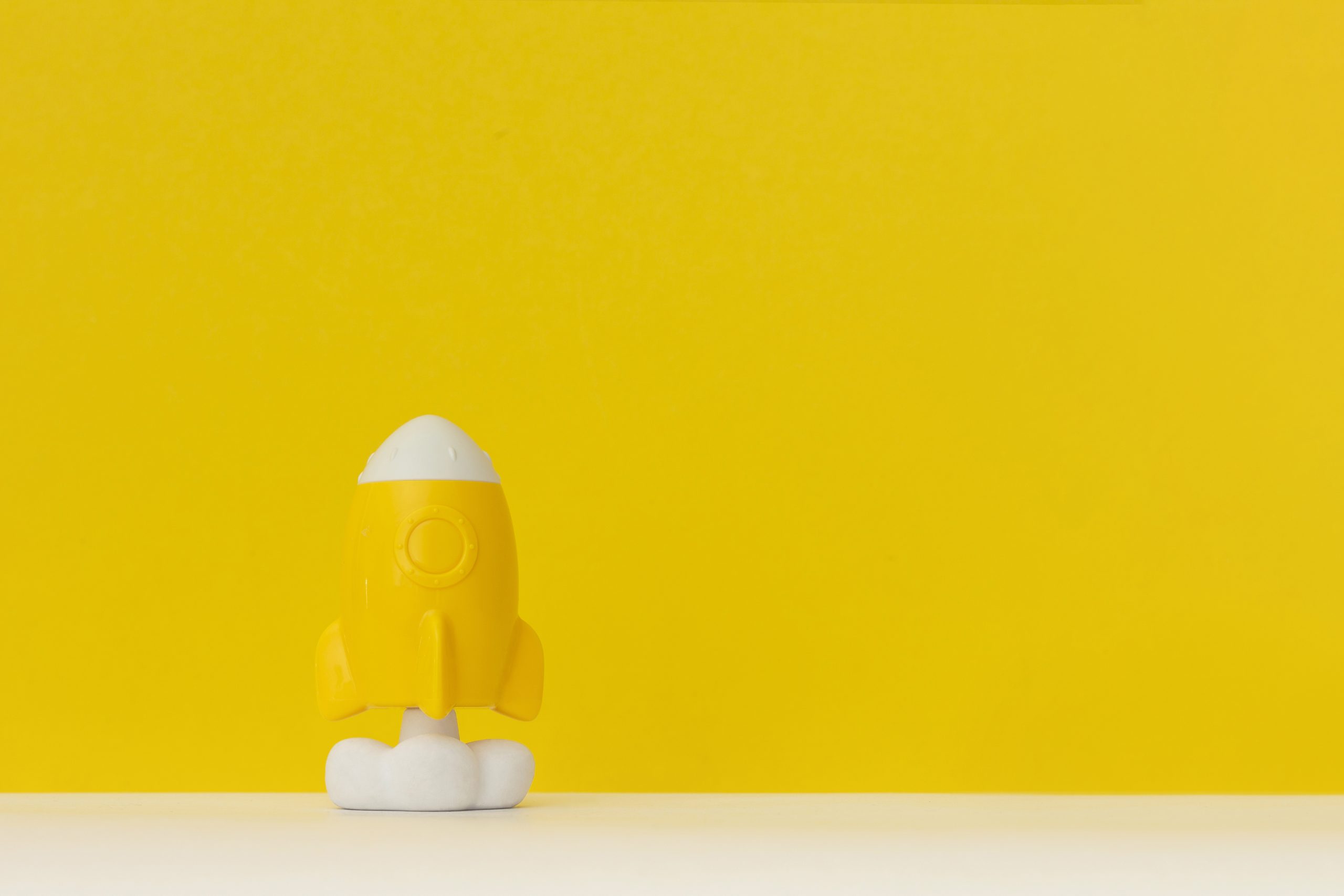 Rocket on left on yellow background, course launch